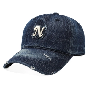 Distressed dark blue denim baseball cap with vintage white N embroidery on a white background