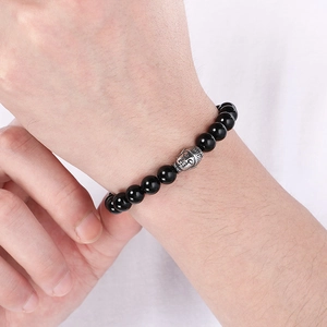 Buddhist Buddha head bracelet with black volcanic tiger eye stone beads on a wrist