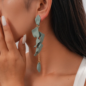 Detail of blue petal fringe earrings with silver needle on model profile view