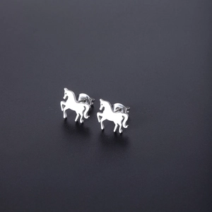 Close-up of silver-tone stainless steel pony stud earrings with a polished metallic finish