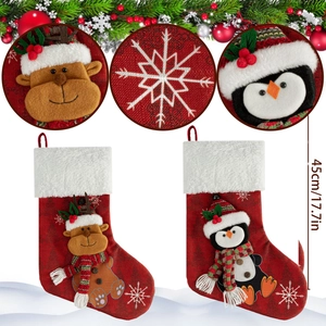 Christmas stockings featuring reindeer and penguin designs, 45cm size with plush cuffs