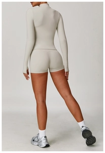 Rear view of slim fit long sleeve yoga jacket and high waist shorts in light grey