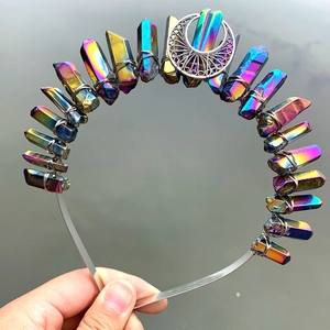 Close-up of handmade rainbow aura quartz crown with metal moon on a headband