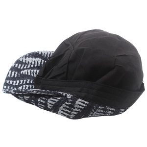 Detail of a double-sided sun hat featuring a black side and geometric pattern cotton fabric