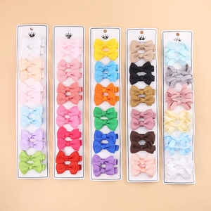 Close-up of grosgrain ribbon hair bows set in multiple colors on display cards