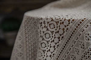 Detail of beige crochet hollow lace curtain showing intricate geometric floral patterns