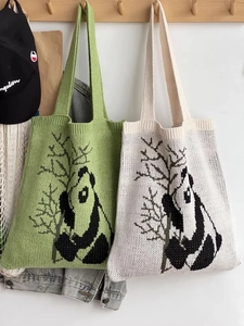 Knitted panda tote bag detail showing green and white colors with bamboo embroidery
