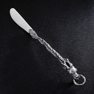 Detailed dragon-themed stainless steel butter knife handle with vintage metal engraving