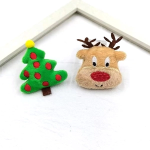 Christmas plush reindeer and green tree accessories with fine embroidery details
