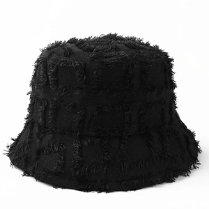 Detailed view of black checkered bucket hat featuring frayed edges and textured fabric