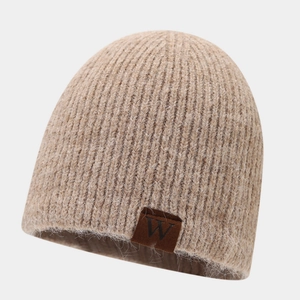 Close-up of oatmeal ribbed beanie with soft mohair texture and brown W leather patch