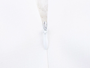 Detailed macro view of the invisible white zipper closure on the long princess dress