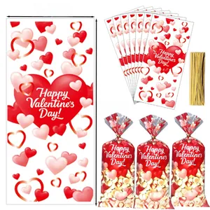 Close-up of Valentine's candy bags with red hearts and gold twist ties, 12.5x27.5cm