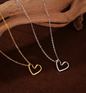 Detail of minimalist 925 sterling silver hollow heart necklaces in gold and silver finish