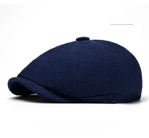 Side view of blue herringbone newsboy cap showing tweed texture and brim detail