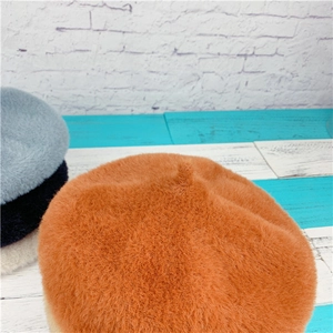 Close-up of plush faux rabbit fur beret collection in various vibrant autumn colors
