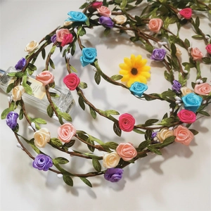 Macro view of handmade floral crown with pink and purple roses on white background
