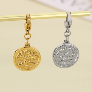 Macro detail of gold and silver tree of life pendants with lobster clasps for jewelry making