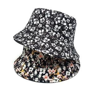 Reversible floral bucket hat for women with black white and colorful flower patterns