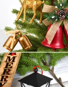 Detail of Christmas tree ornaments featuring golden elk, red bells, and vintage lanterns