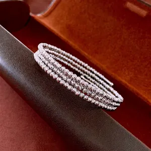 Three-layer silver twisted beaded bracelet with faceted diamond-cut texture details