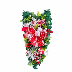 Christmas teardrop swag with candy ornaments, red bows and green pine branches decoration