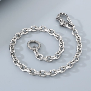 Detail of silver wolf head buckle and stainless steel chain for punk style jeans