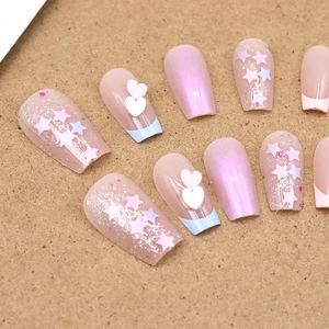Sparkly pink press-on nails set with glitter hearts and 3D stars on kraft background