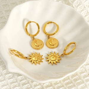 Retro 18K gold plated titanium steel hoop earrings featuring sun and moon face charms