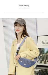 Blue multi-zippered crossbody chest bag with adjustable strap shown on female model