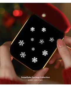 Macro shot of S925 silver snowflake stud earrings with sparkling zircons in holiday setting
