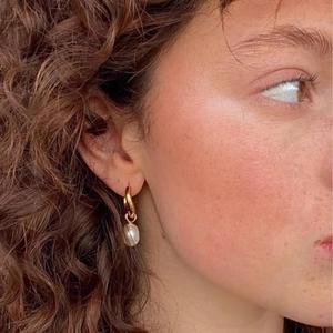 18K gold plated stainless steel hoop earrings with a single freshwater pearl on model
