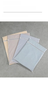 Macro shot of durable mesh laundry bags with zipper closure in various pastel colors