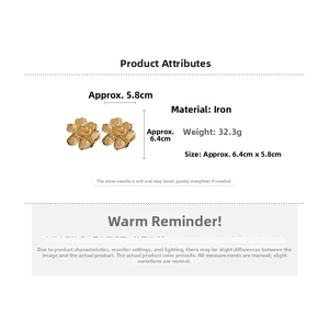 Detail showing oversized gold flower earrings with silver posts and product dimensions