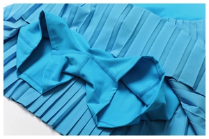Close-up of sky blue pleated tennis skirt showing built-in shorts and reinforced stitching
