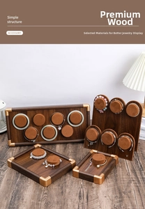 Macro view of walnut wood jewelry display tray with brown velvet pillars and gold corners