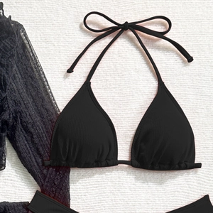 Close-up of black ribbed bikini with halter neck tie and lace cover-up sleeve detail