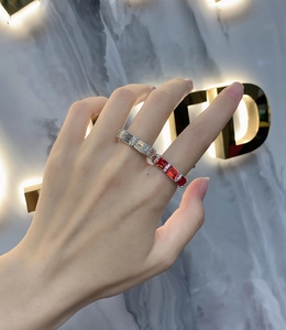 S925 silver ring with emerald-cut red and white gemstones worn on a finger