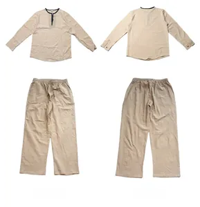Detail view of men's linen beach set showing front and back of Henley shirt and trousers