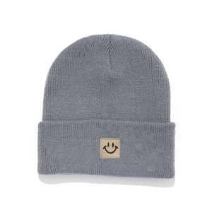 Classic dark grey knitted beanie for kids featuring a cute smiley face patch and cuff