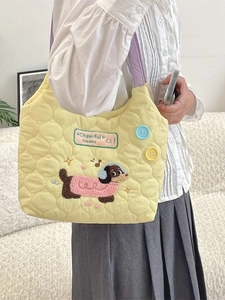 Quilted yellow cotton tote bag with cartoon dog embroidery and purple handles