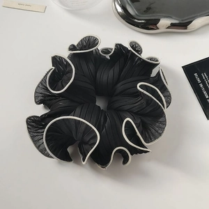 Elegant large black organza scrunchie with white piped edges and pleated texture