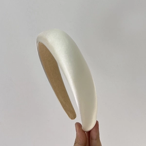 Detailed shot of white padded sponge headband with brown lining for vintage hair styling