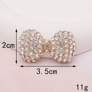 Macro shot of rhinestone bow accessory with dimensions 3.5cm by 2cm and 11g weight