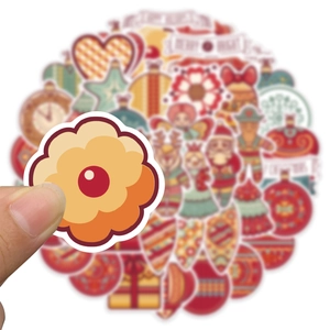 Close-up of waterproof Christmas stickers featuring Santa, reindeer, and cookies