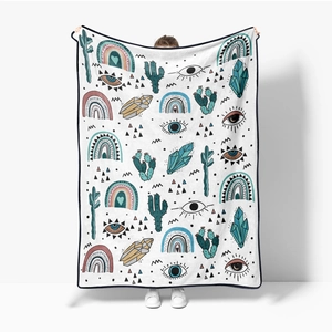 Detail of soft flannel blanket featuring bohemian cactus and evil eye mystic patterns