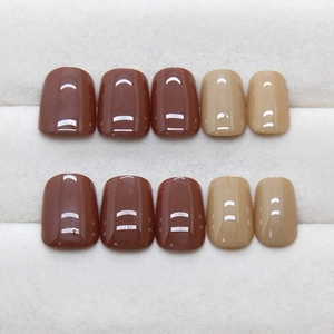 Mocha brown and cream press-on nails with a glossy finish in a short square-oval shape