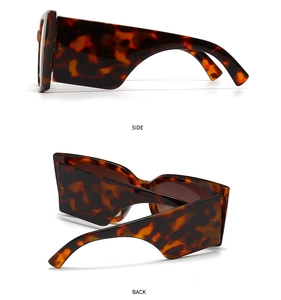 Detail view of retro tortoise shell sunglasses with wide side wings and bold square frame