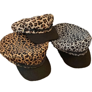 Three stylish Y2K leopard print newsboy caps in brown, yellow, and grey with black brims