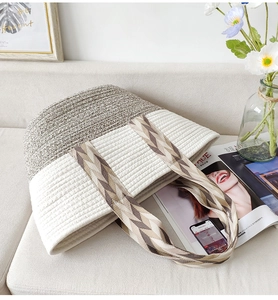 Macro detail of handwoven cotton rope tote bag showing contrast stitching and textured weave